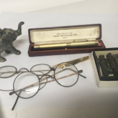 A cased Swan fountain pen a similar pencil an elephant table lighter and silver pencils and oddments.