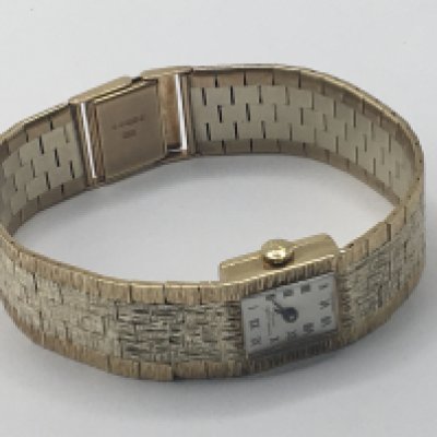 A ladies 9carat gold two tone Favre-Leuba manual wind watch with a rectangular dial seen working in good condition. All in weight 37.5g