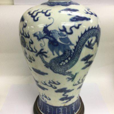 A large blue and white baluster vase decorated with a dragon chasing a pearl raised on a hardwood stand, approx height 43cm. Shipping category D.