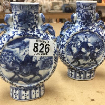 A matched pair of 19th Century blue and white moon vases decorated with figures on horseback. Measuring 16cm in height approximately
