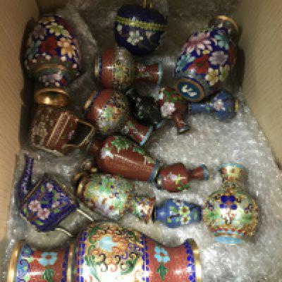 A box containing miniature cloisonn&eacute; vases and tea pots
