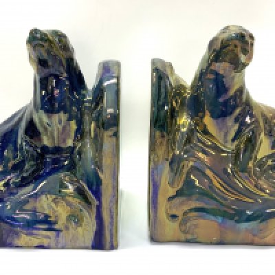 A pair of Art Deco bookends in the form of two ceramic basking seals by Alphonse Cyt&egrave;res (1851-1941) for Rambervillers, Vosges.