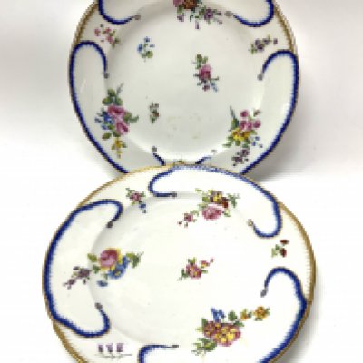 Two variations Soft-Paste S&egrave;vres Porcelain plates 23.5cm diameter, Circa 1790, one with the factory mark in blue , one black enclosing the date letters, adjacent painter&rsquo;s mark P, for Jean-Jacques Pierre, known as Pierre . (D. In house postage not available for this lot).