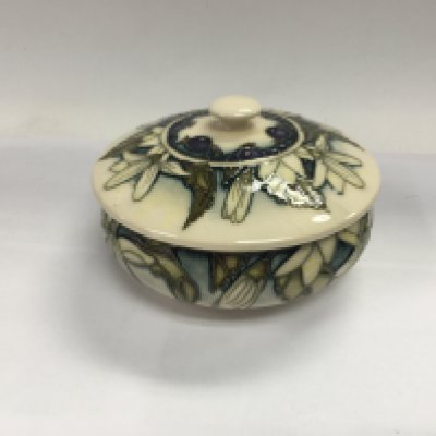 A Moorcroft powder juneberry bowl with cover.