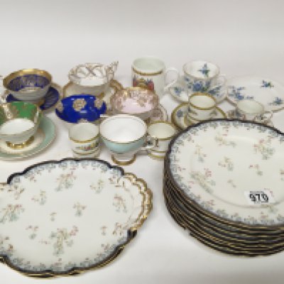 A French Porcelain dinner service and a quantity of porcelain cups a d saucers.