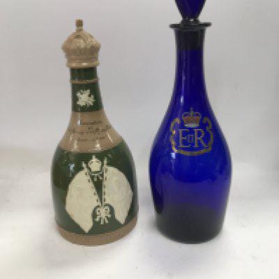 A Spode ceramic coronation decanter and a Queen Elizabeth silver jubilee decanter.