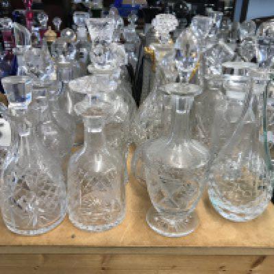 A large collection of cut glass decanters. Approx 20 decanters.