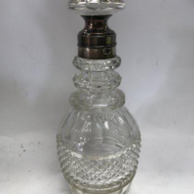 An unusual 19th century cut glass silver collared lockable decanter with another fancy cut glass silver collared decanter and two other collared decanters.