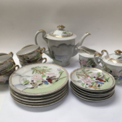 A Japanese eggshell tea set with geisha girls cups.