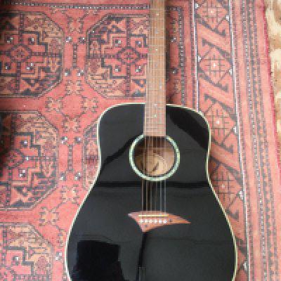 A Dean TS CBK acoustic guitar with a soft carry case.