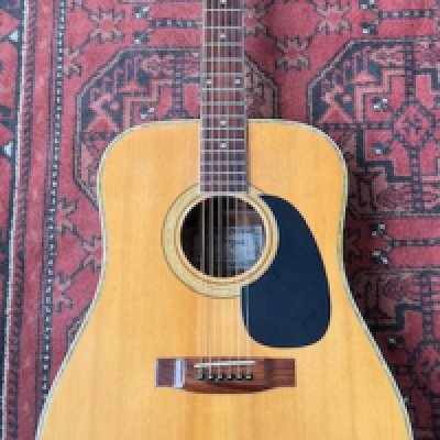 A 1980's Kiso Suzuki KW150 Dreadnought guitar in good condition with playwear to the top. Mother of pearl binding and three piece back.