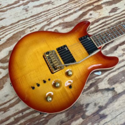 A 1999 Yamaha MSG Custom solid body electric guitar in Sunburst with Mahogany Body and Rosewood Fingerboard. Guitar designed by U.K. Luthier Martin Booth for Yamaha. Comes with gold plated brightwork and Yamaha Custom HLPS Pickups. This Guitar is in very good condition with light playwear, frets in good overall condition and one small chip in the top. Overall very good.