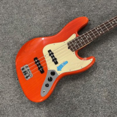 A Fender Jazz Bass Guitar Made in USA 2005 with Rosewood Fingerboard in Sunset Orange Transparent finish . Condition is as new with plastic and indicator sticker still on pickguard. Comes with original Fender Hard Case.
