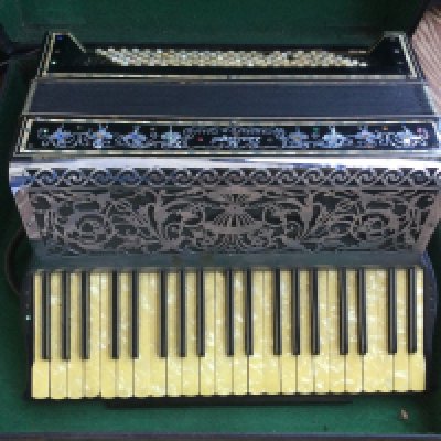 A cased Dallape accordion.