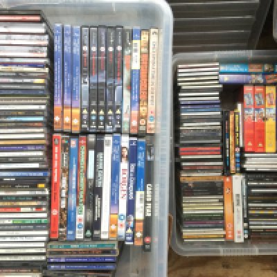 Five boxes of CDs, DVDs and VHS tapes. Artists include John Lee Hooker, Arctic Monkeys, Bon Jovi and many more.