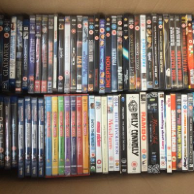 A box of DVDs and BluRays comprising TV series and films.