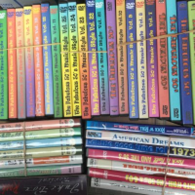 A box of rock n roll DVDs comprising various compilations.