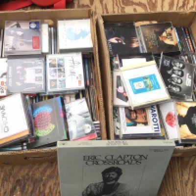 Two boxes of CDs by various artists including an Eric Clapton 'Crossroads' 4CD set, Adele, Pearl Jam, Green Day, Paul Weller and many more.