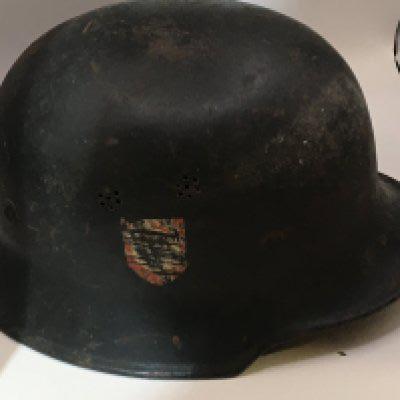 A German Third Reich II world war military helmet original condition with double side decals has a worn but original liner. The helmet with air breather holes and inner edge stamp mark