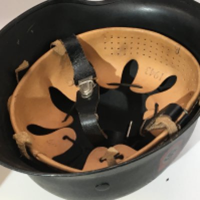 A German Third Reich helmet with double decal finished in black with a leather liner most probably a retrospective copy or refurbished.