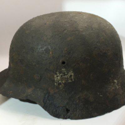 A rediscovered Excavated German Third Reich M35 pattern helmet traces of a single decal the interior edge with stamp mark possible 353.