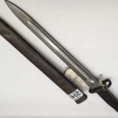A British bayonet conforming to 1907 pattern with metal scabbard. The top handle grip fitting stamped 17190. Length 45cm