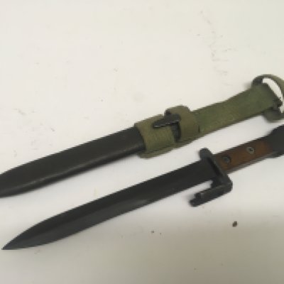 A foreign bayonet with wood grip stamped 12530.