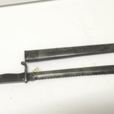A German sawback edge Mauser bayonet with wood grip the blade stamped with makers marks and with steel scabbard. length 52cm