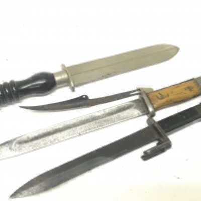 A German bayonet one other foreign bayonet an Ebony handled fighting knife no scabbards.