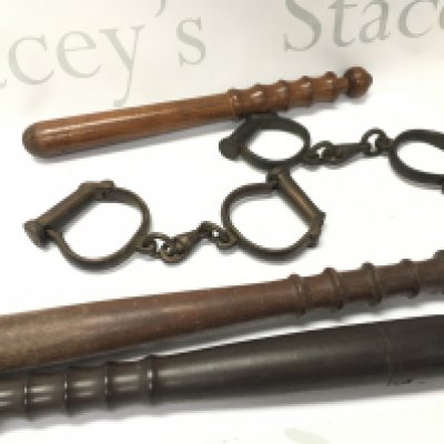Three truncheons and two pairs of handcuffs. Postage cat b