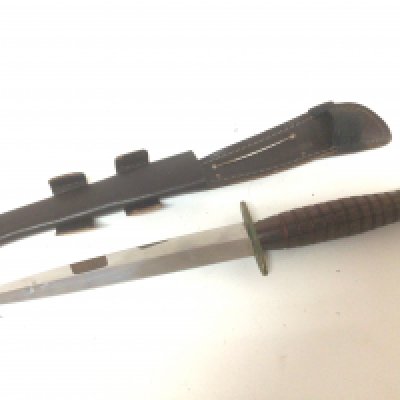 A post II world war Fairbrain Sykes Commando fighting knife with turned hardwood handle maker R Cooper Sheffield. Stamped.