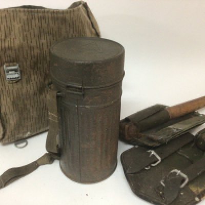 Two military folding shovel picks with wooden handles a German Auer gas mask in a circular container and a military kit bag (4)