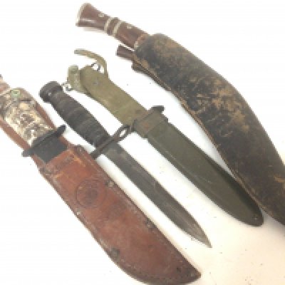 An American Military bayonet a Kukri knife and a USMC hunting knife.