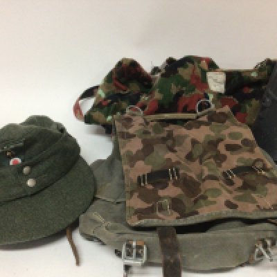 A German Military cloth cap a small rucksack and other camouflage and a tin