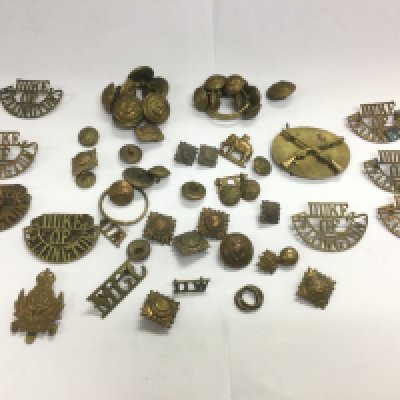 A collection of military badges and buttons, Duke Of Wellingtons regiment. Shipping category A.