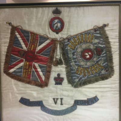 A framed and glazed British military silk for The Royal Warwickshire Regiment, approx 64cm x 64cm. Shipping category D.