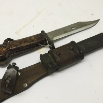 An Early Example of an AK47 bayonet with leather attached frog the cross guard stamped AEP 1059. With Bowie type blade and saw edge.
