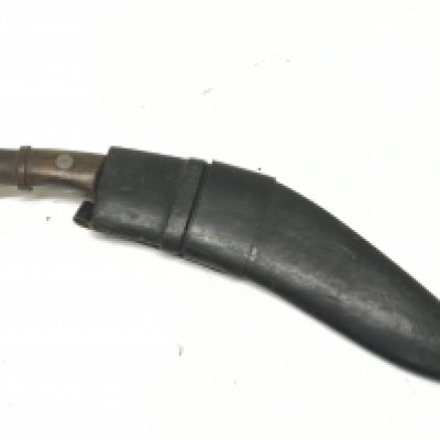 A Vintage Kukri Knife with a wood handle and leather scabbard.