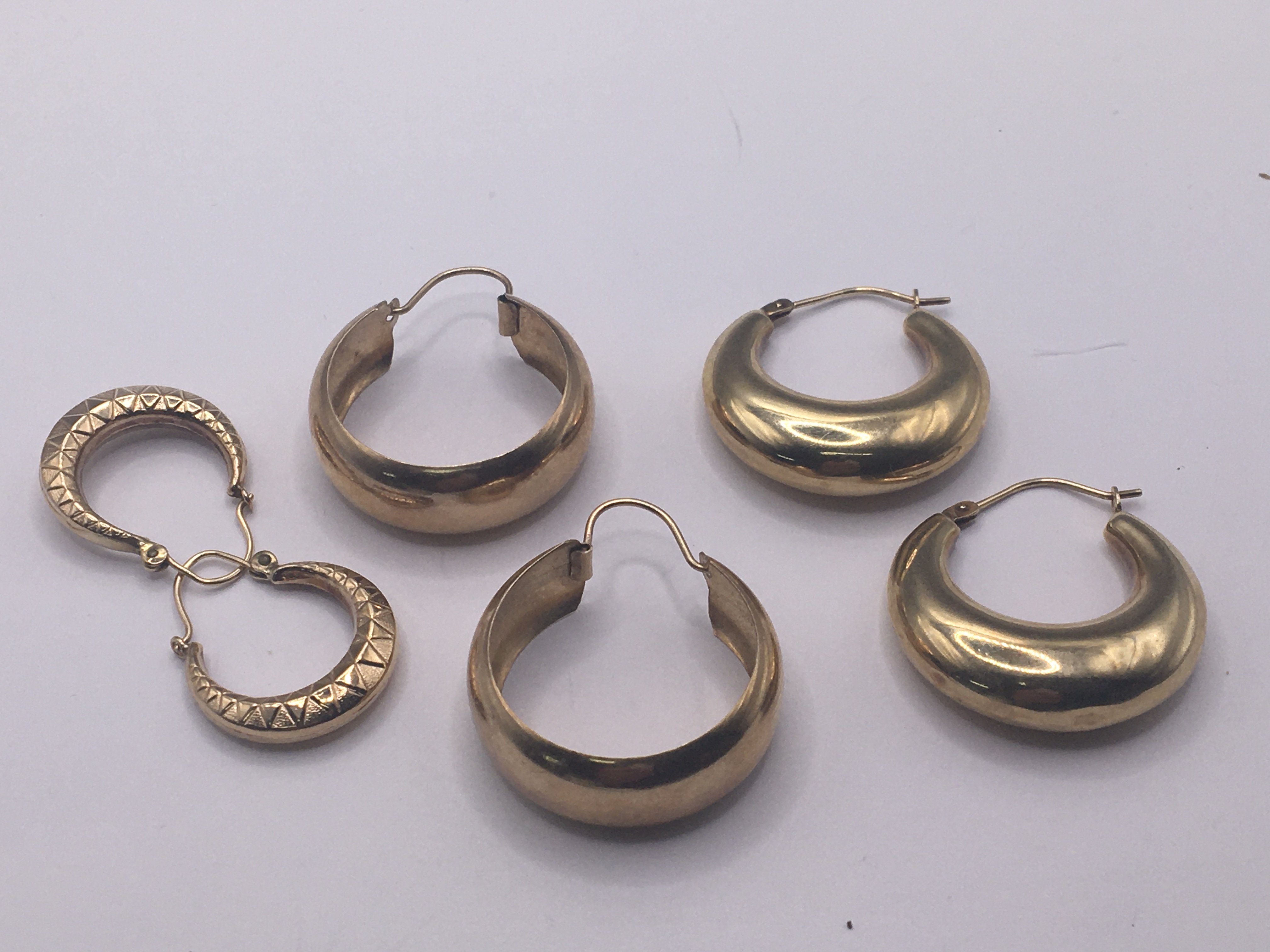 A collection of 9carat gold hoop earrings. Weight 8g