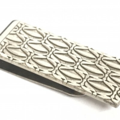 A white metal money clip marked Cartier made in Italy. Postage category A