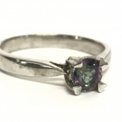 A silver ring set with a green & purple iridescent stone. Postage category A