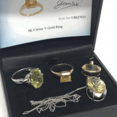 A 9 carat gold yellow Citrine pendant, 9 carat gold yellow citrine set ring, a silver ring set with a green citrine stone and a 9 carat white gold pendant set with a green citrine stone on a 9 carat white gold necklace. Total weight 12.8g Postage category A