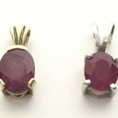 A 9ct white gold ruby pendant and a 9ct yellow gold ruby pendant. With certificates. Total weight 2g Postage category A