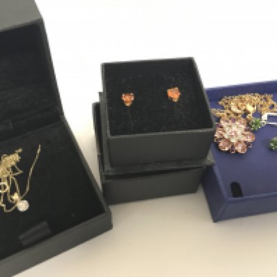 A boxed Swarovski Disney flower necklace, 9 carat gold earrings fire opal earrings, 9 carat gold pendant set with a diamond stone and chain, silver earrings with green stones etc. Total gold weight 1.7g Postage category A