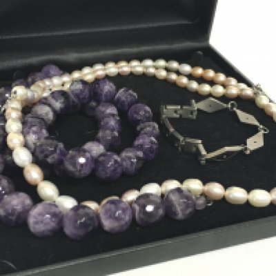 A pearl necklace, a beaded amethyst necklace, matching bracelet and a titanium bracelet. postage category B