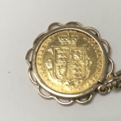 An 1860 half shield back sovereign on a 9ct gold chain. 9.90g total weight.