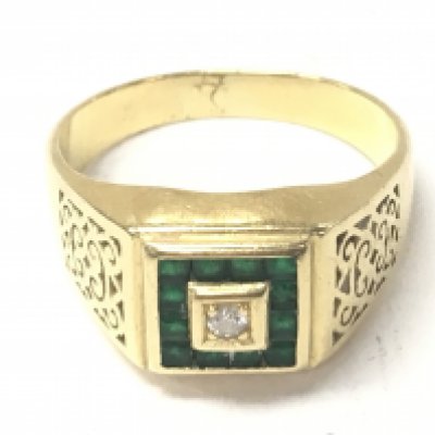 An 18ct emerald and diamond signet ring. Size X and 9.60g.