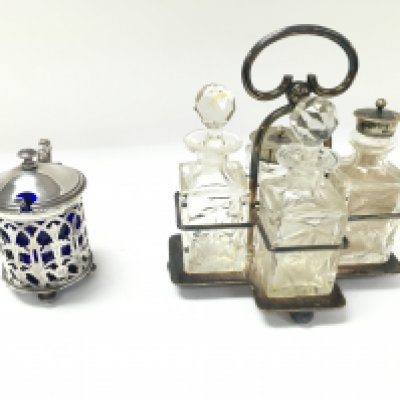 A Christofle mustard pot and silver spoon along with a silver plate cut glass condiment set in caddy