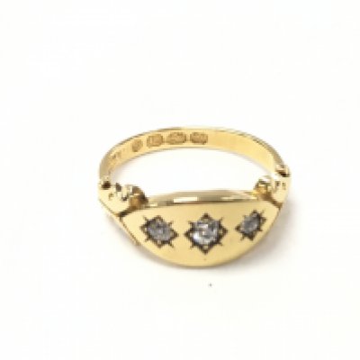 An 18ct gold gents ring set with three diamonds. Size K and 3.08g. Postage A