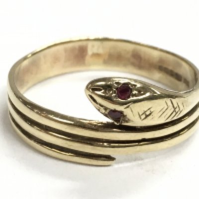 A 9 carat gold snake ring set with red stones to the eyes, 3.8g. size Y. Postage category A